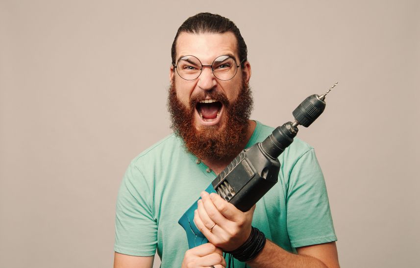 A man holding a drill